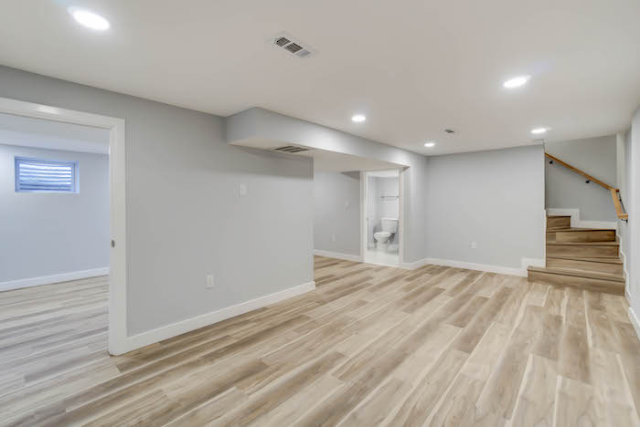 A freshly finished basement with new floors, ready for move-in