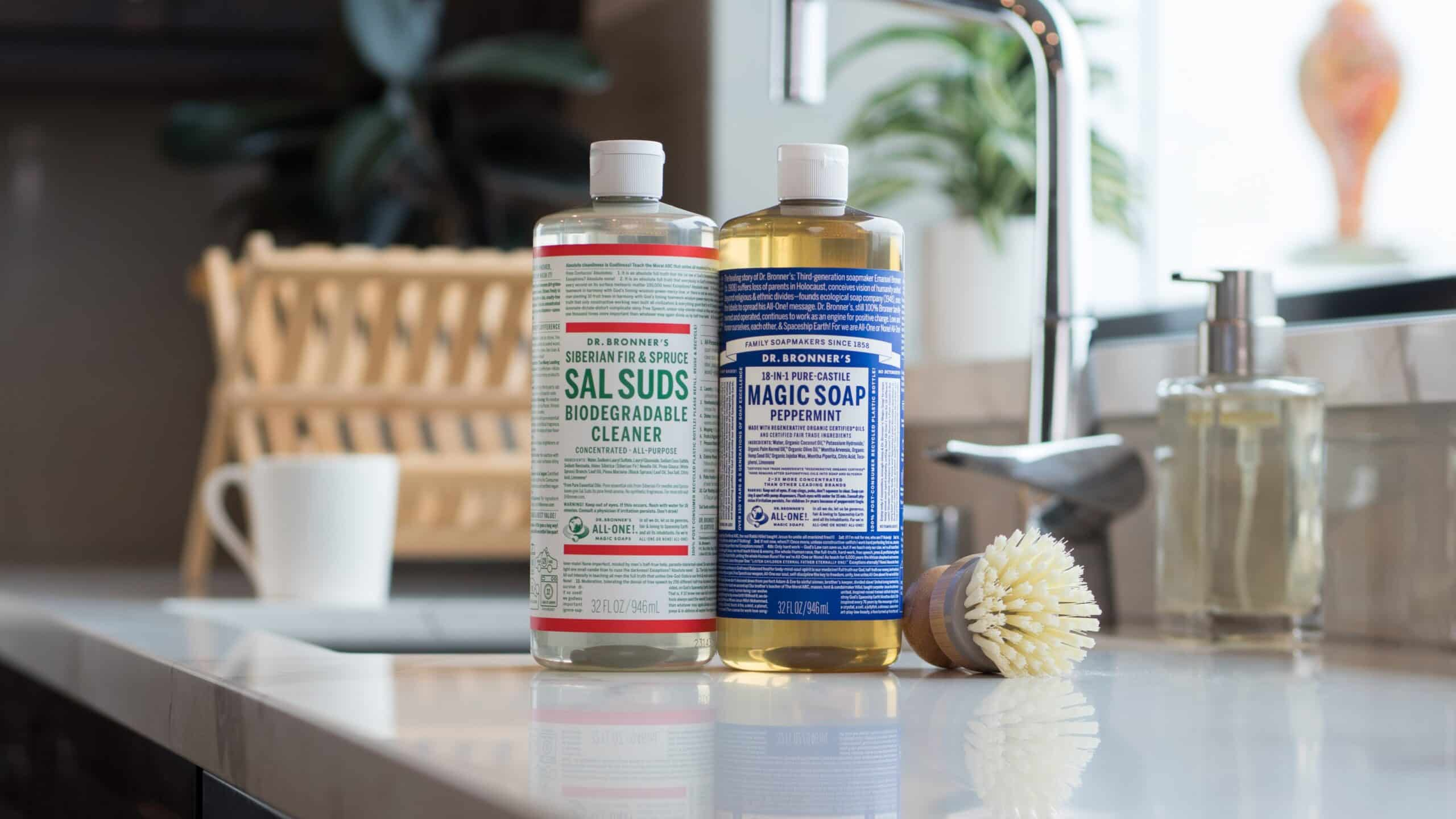 Dr. Bronner's Sal Suds biodegradable cleaner and Pure-Castile peppermint soap on a kitchen counter