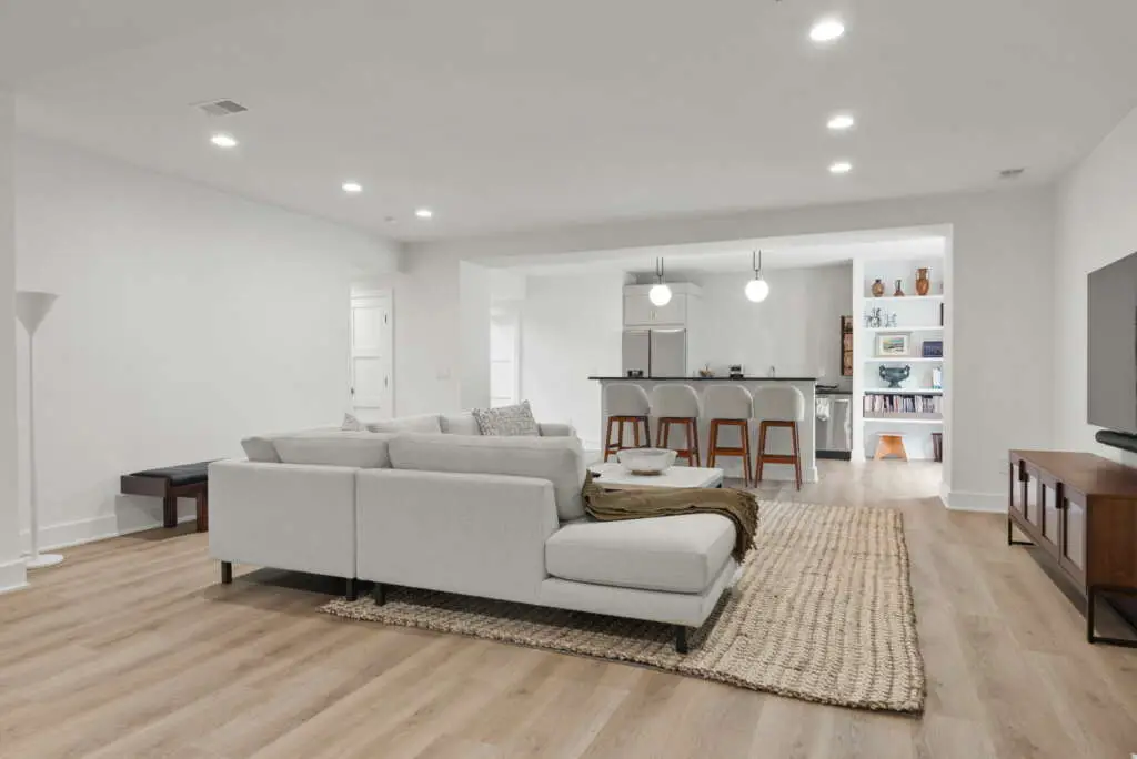 An open living room and kitchen with clean floors and tidy surfaces